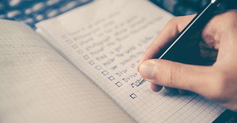 Transcript Assessment Document Checklist A photo of a notebook where a person is writing a checklist with boxed in front of each points.
