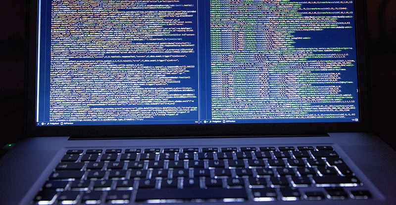 A photo of a laptop with the screen open to show it is running codes.