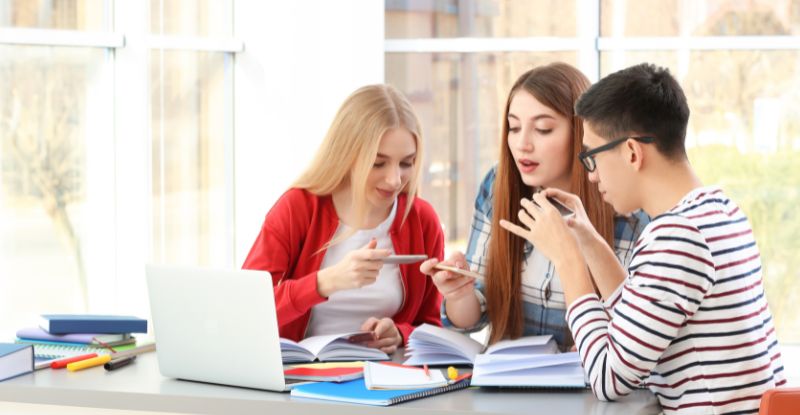 A photo of students sneakily taking photos of notes.