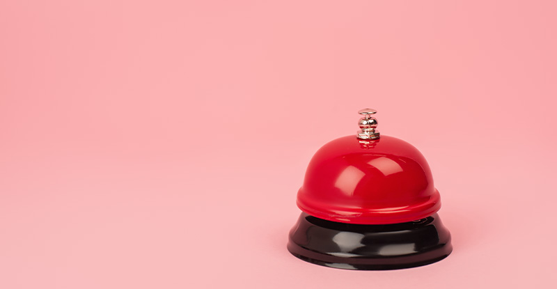 A photo featuring a pink background with a red call bell is placed on the lower right corner of the photo.