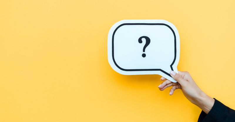 An illustration against a blue background featuring a person holding a question mark card.