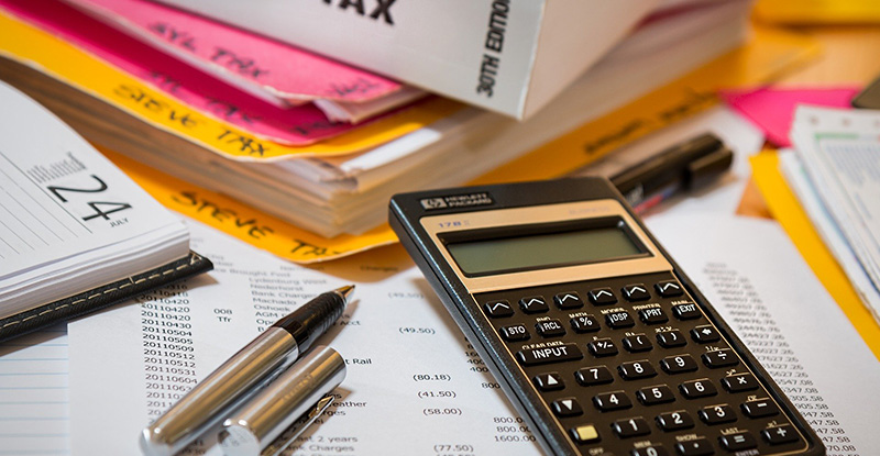 Your 2019 Tax Receipt A photo of tax papers spread out on a table with a calculator placed at the top.